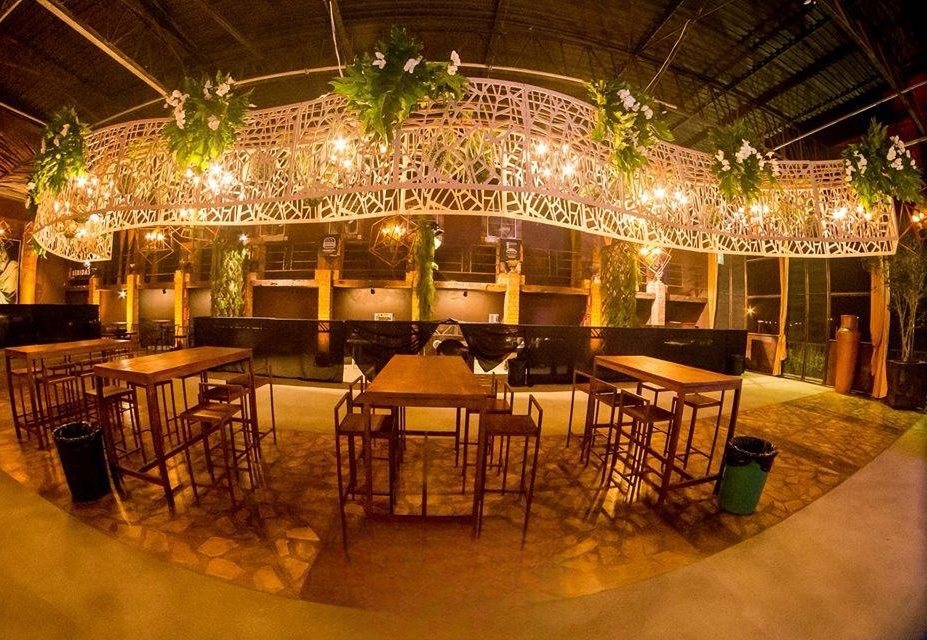 Área de bar com estrutura suspensa e paisagismo